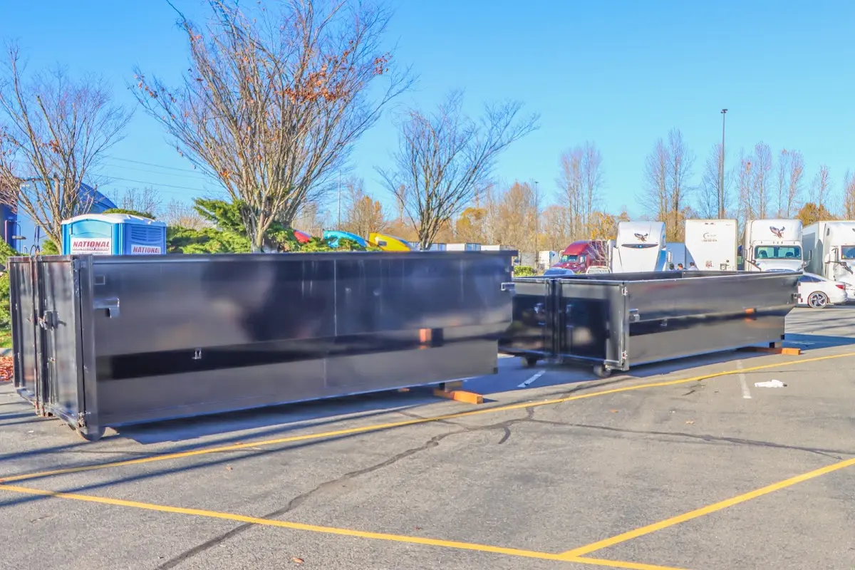 Professional dumpster rental service with roll-off container on residential driveway in Oroville